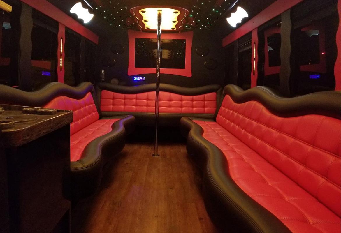 Red leather interior seating inside a luxury party bus for Temecula group celebrations