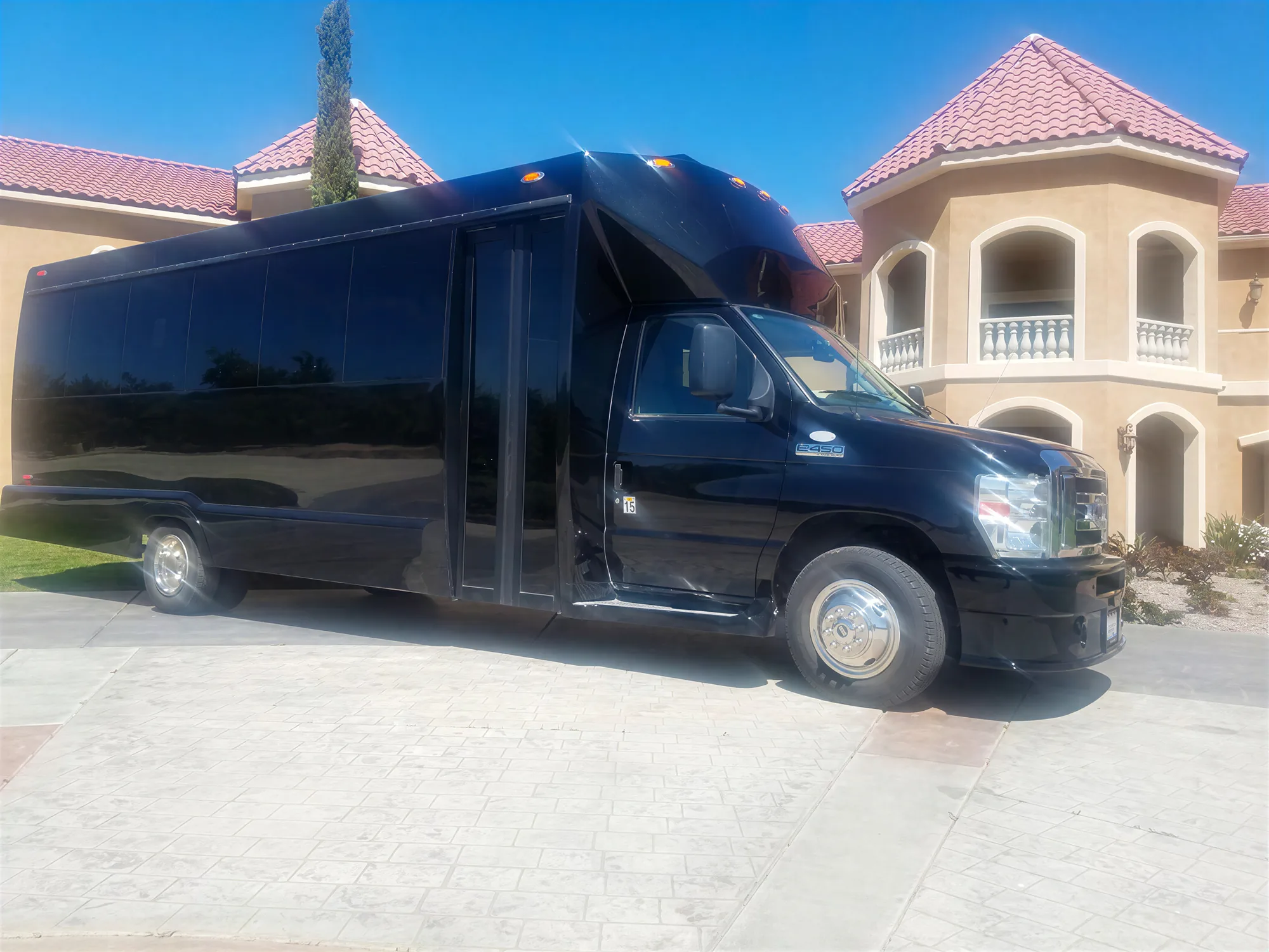 Luxury Temecula party bus parked outside winery estate during wine tour
