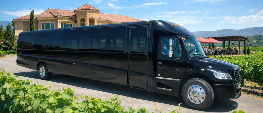 Black party bus parked among the vines at a Temecula Valley winery